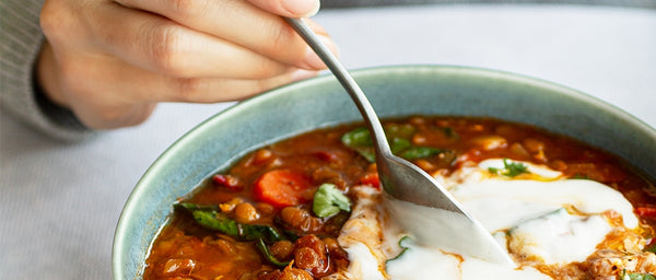 Vegetable soup topped with yogurt.