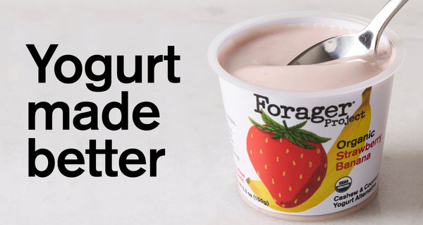 Spoon scooping strawberry banana yogurt out of its container.