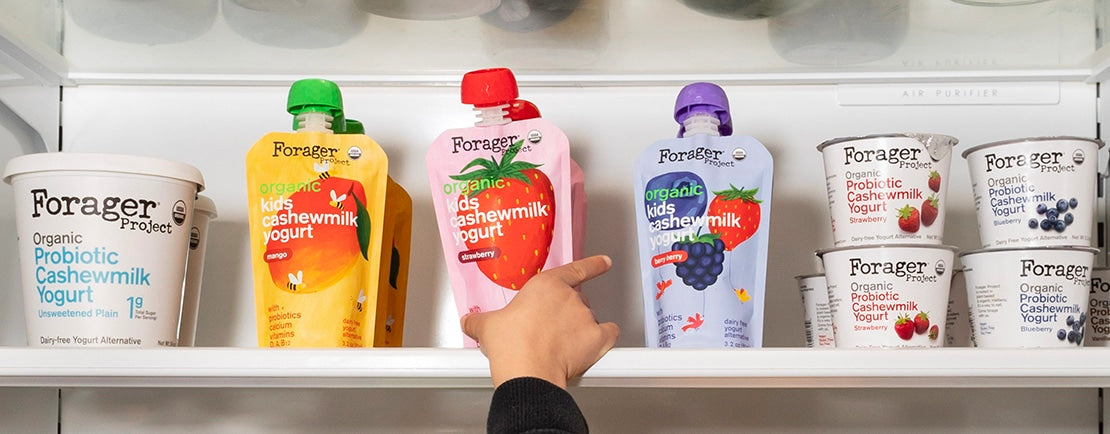 kids hand grabbing an organic cashewmilk yogurt pouch