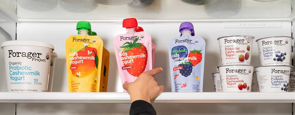 kids hand grabbing an organic cashewmilk yogurt pouch