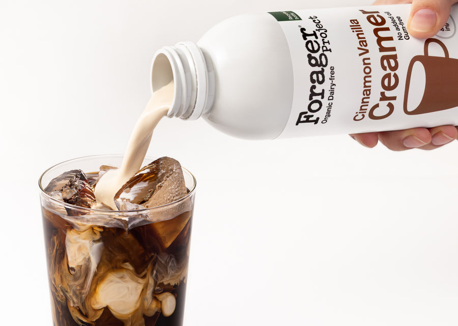 Forager Project Cinnamon Vanilla Creamer being poured into a glass of iced coffee.