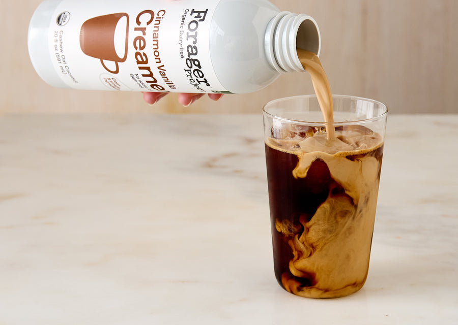 Cinnamon Vanilla Creamer being poured into a glass of coffee.