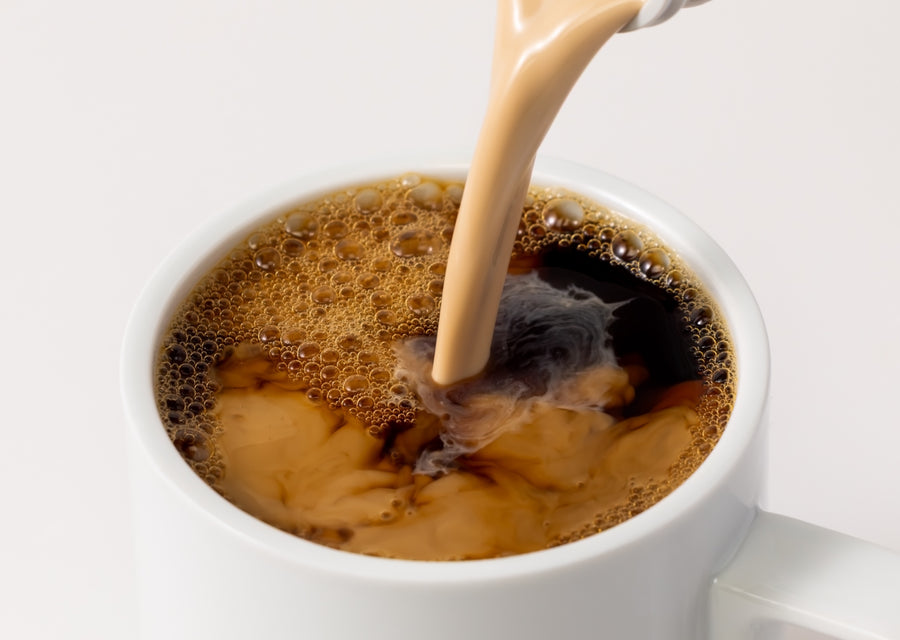 White mug with coffee being poured with Cinnamon Vanilla Creamer
