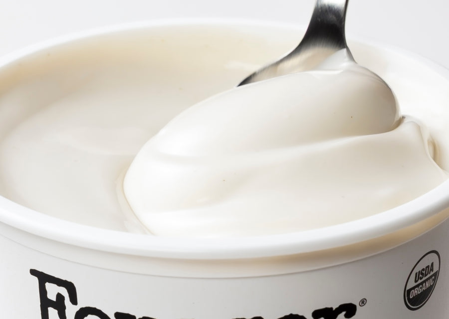 Yogurt in a container with a spoon, featuring the USDA Organic logo.