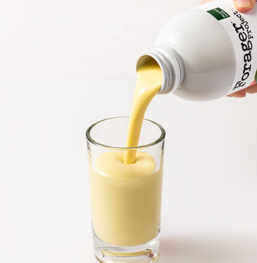 Bottle of Forager milk being poured into a glass