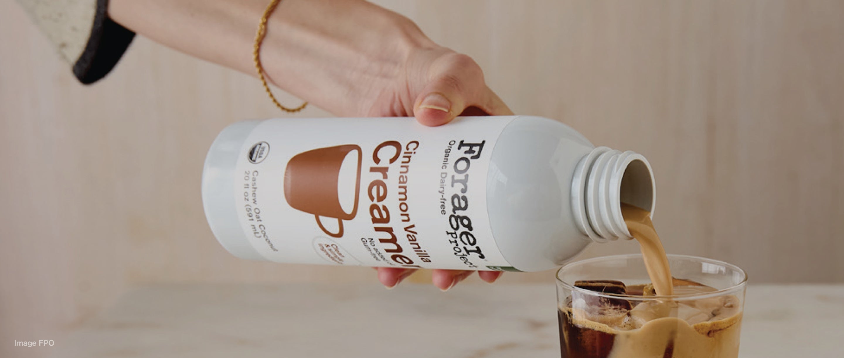 Organic Dairy-free Cinnamon Vanilla Creamer poured into a glass of coffee