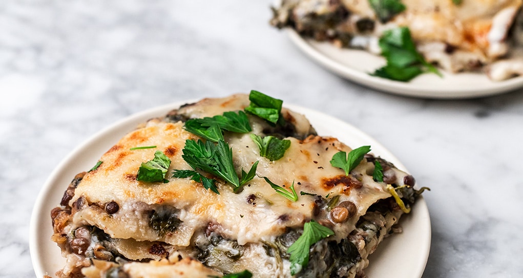 Serving of a spinach and lentil lasagna.