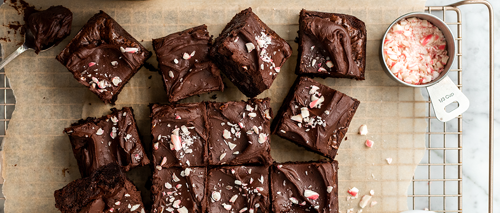 Overhead of vegan chocolate peppermint brownies topped with candy canes